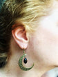 Close-up of a woman wearing a Witchy Celestial Moon Dangle Earring - Handmade Toronto Jewelry