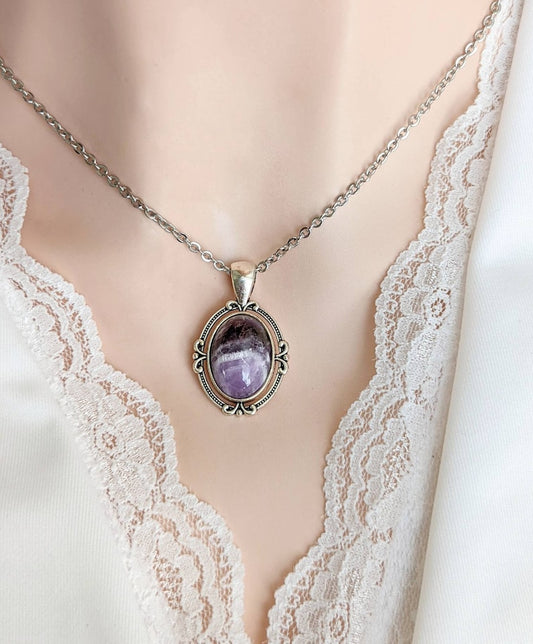 Purple Amethyst Crystal Necklace - Silver Flourish Pendant Setting on a mannequin wearing a lace top.