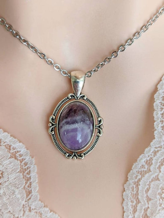 Purple Amethyst Crystal Necklace - Silver Flourish Pendant Setting necklace on a mannequin bust with lace details