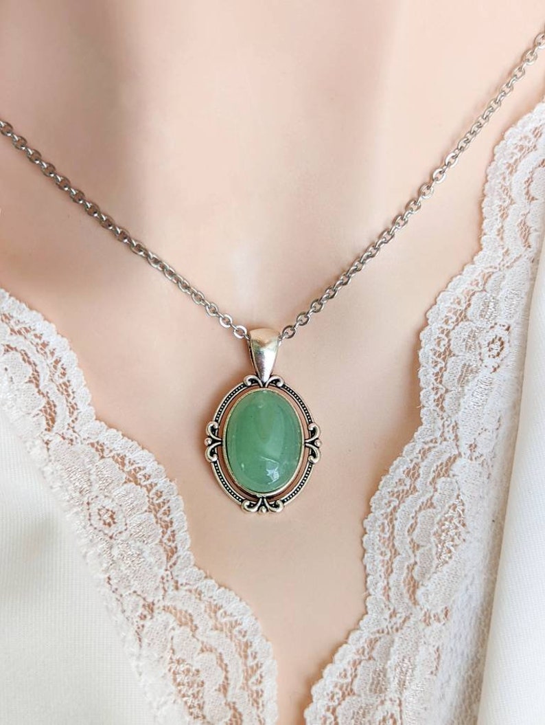 Green Aventurine Crystal Necklace - Silver Flourish Pendant Setting on a mannequin wearing a lace garment