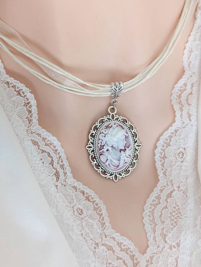 Faded ruby Lady Cameo on Cream Organza Ribbon Choker in Silver Victorian Setting.