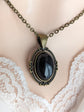Black Obsidian Crystal Necklace - Bronze Flourish Pendant Setting on a mannequin bust wearing lace