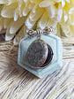 Silver round floral etched locket brooch pin partly open, by Papillion Era