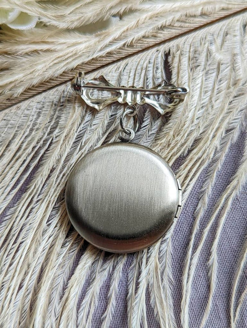 Back view of silver round floral etched locket brooch pin by Papillion Era