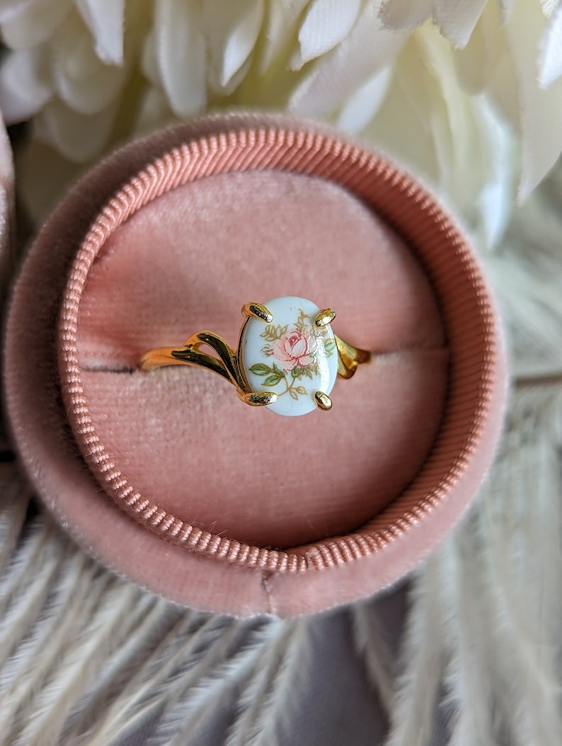 Pink Rose Cameo Ring - Gold Vermeil Sterling Silver Adjustable Band on a pink velvet cushion.