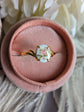 Pink Rose Cameo Ring - Gold Vermeil Sterling Silver Adjustable Band on a pink velvet cushion.