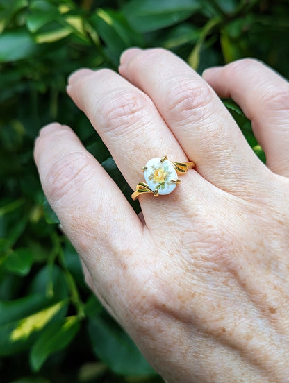 Hand wearing a Gold Vermeil Yellow Rose Ring - 925 Sterling Silver - Victorian Floral Jewelry against a green leafy background