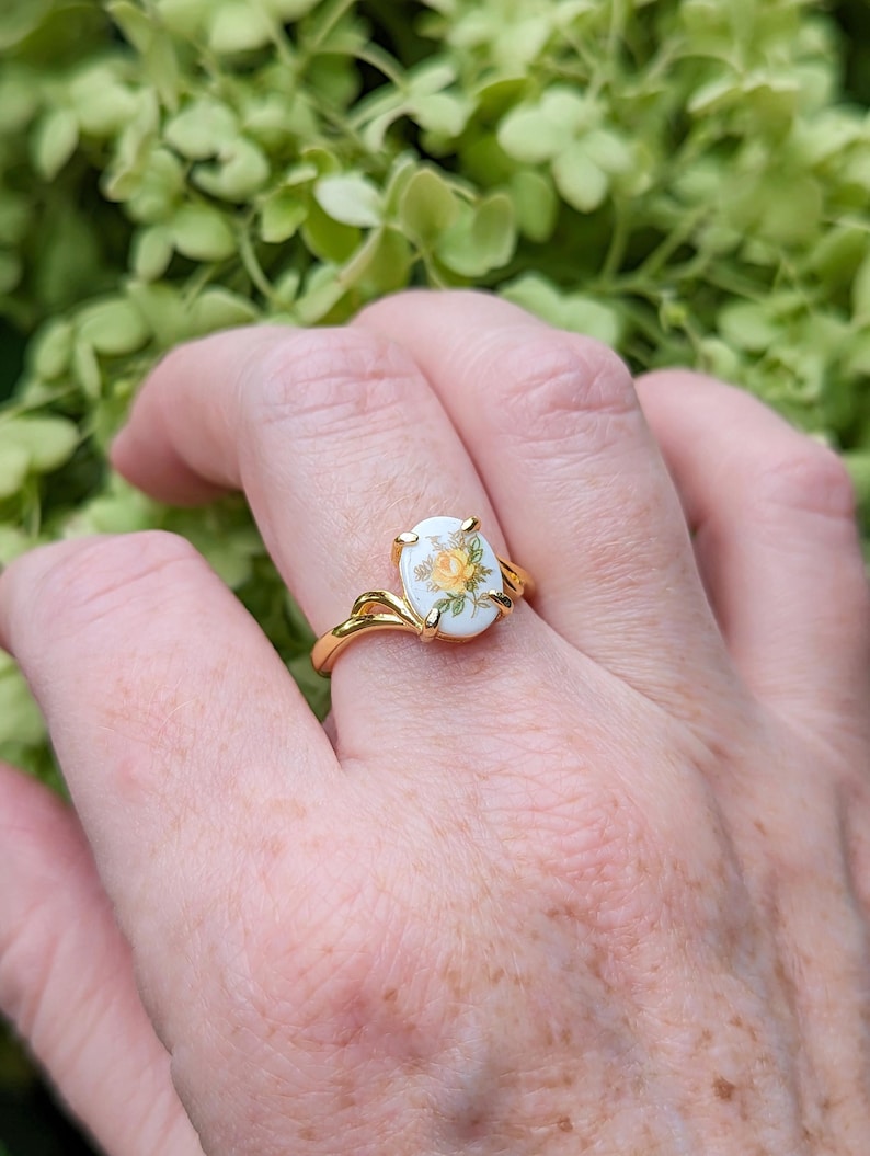 Yellow Rose Cameo Ring - Gold Vermeil Sterling Silver Adjustable Band on a hand against a green leafy background