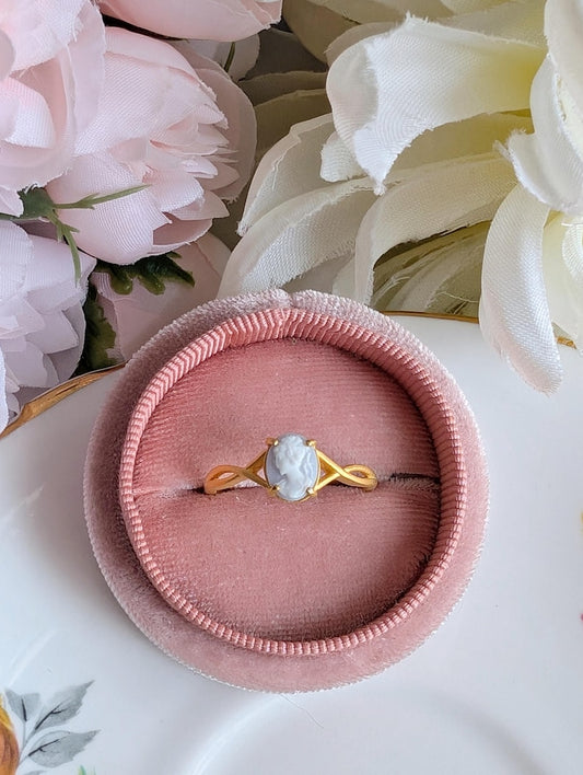 Matte gold cameo ring with single loop shoulder detail in pink jewelry box.