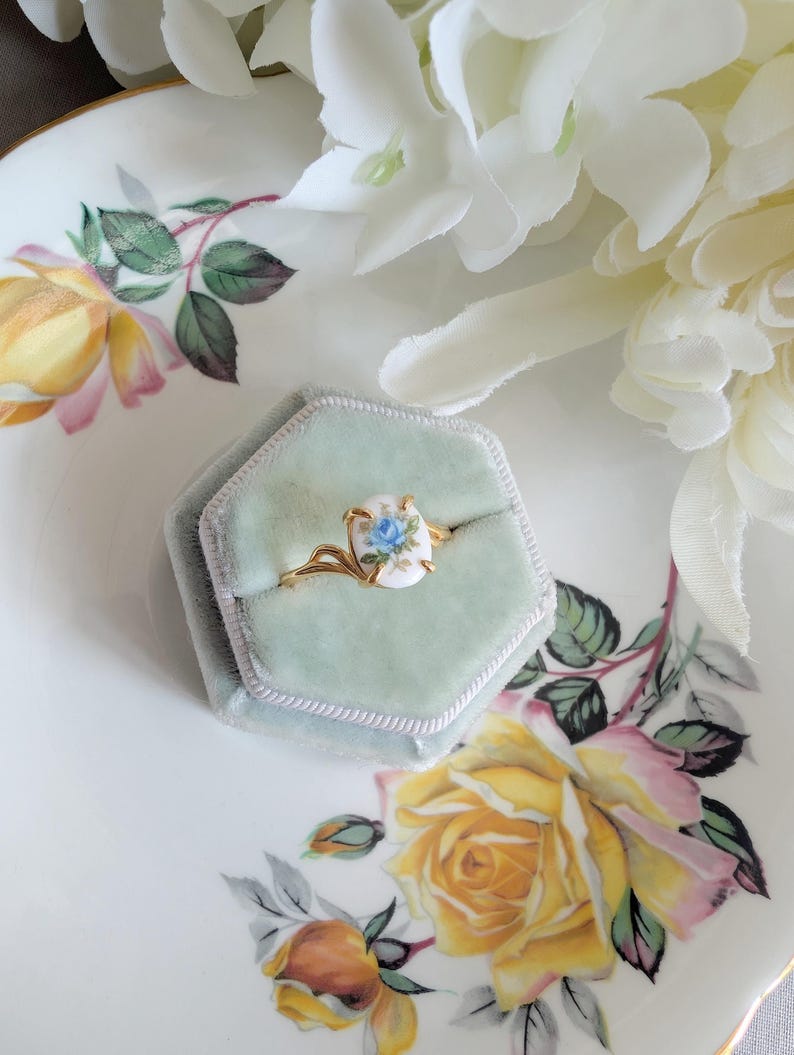 Gold Vermeil Blue Rose Ring - 925 Sterling Silver - Victorian Floral Jewelry in a hexagonal box on a floral-patterned plate