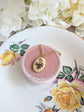 Two-tone Pink Floral Bouquet Necklace - Vintage 1980s Ivory Porcelain Cabochon on a pink jewelry box against a floral background