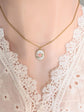 Vintage 1980s Pink Rose Necklace - Limoges Style Porcelain on White Background on a mannequin wearing a lace top.