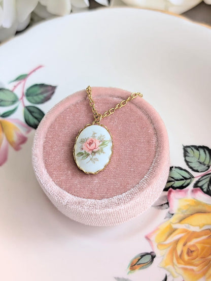 Vintage 1980s Pink Rose Necklace - Limoges Style Porcelain on White Background on a pink jewelry box on a decorative plate