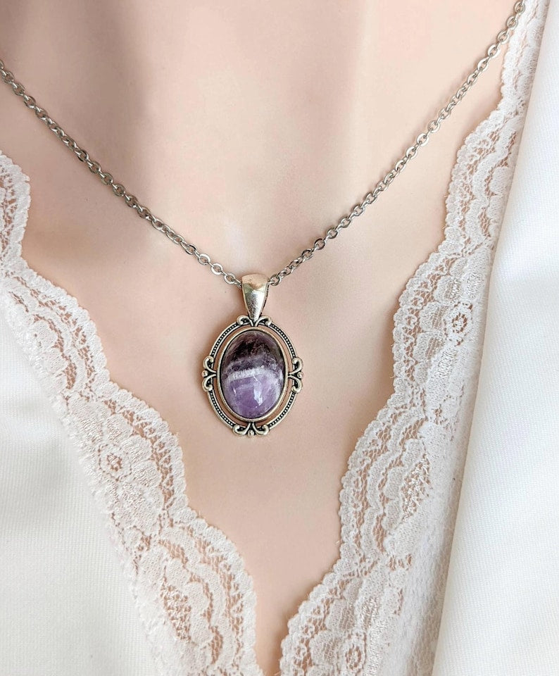 Purple Amethyst Crystal Necklace - Silver Flourish Pendant Setting on a mannequin wearing a white lace garment.