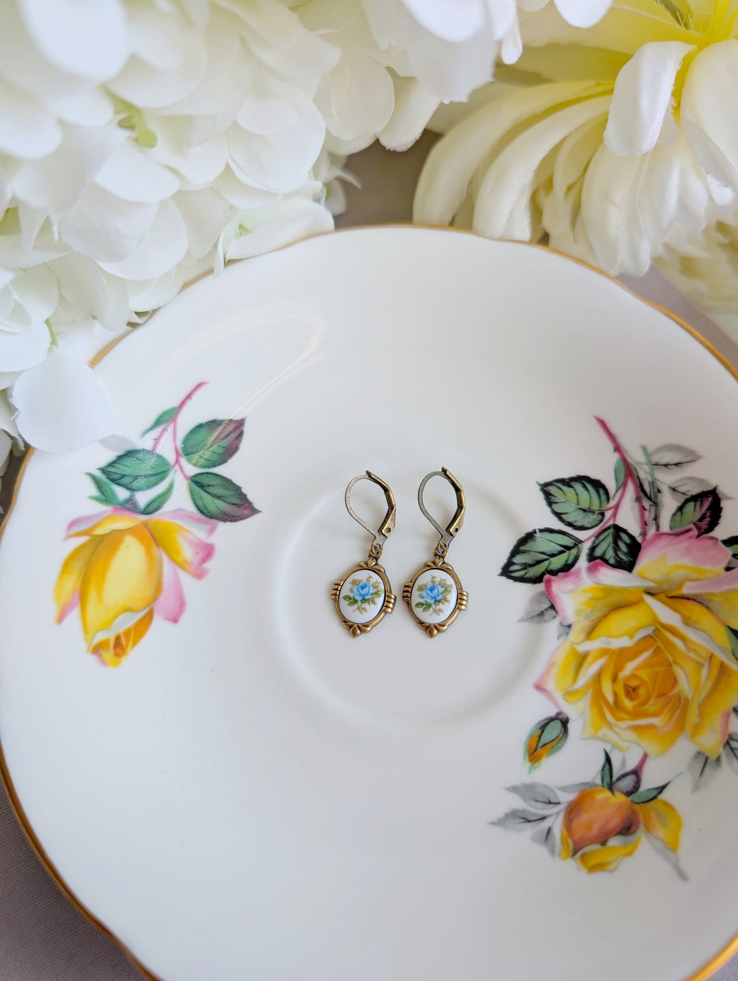 Blue Floral Porcelain Cabochon Earrings - Art Deco Frame - Victorian Style on a decorative plate with floral designs