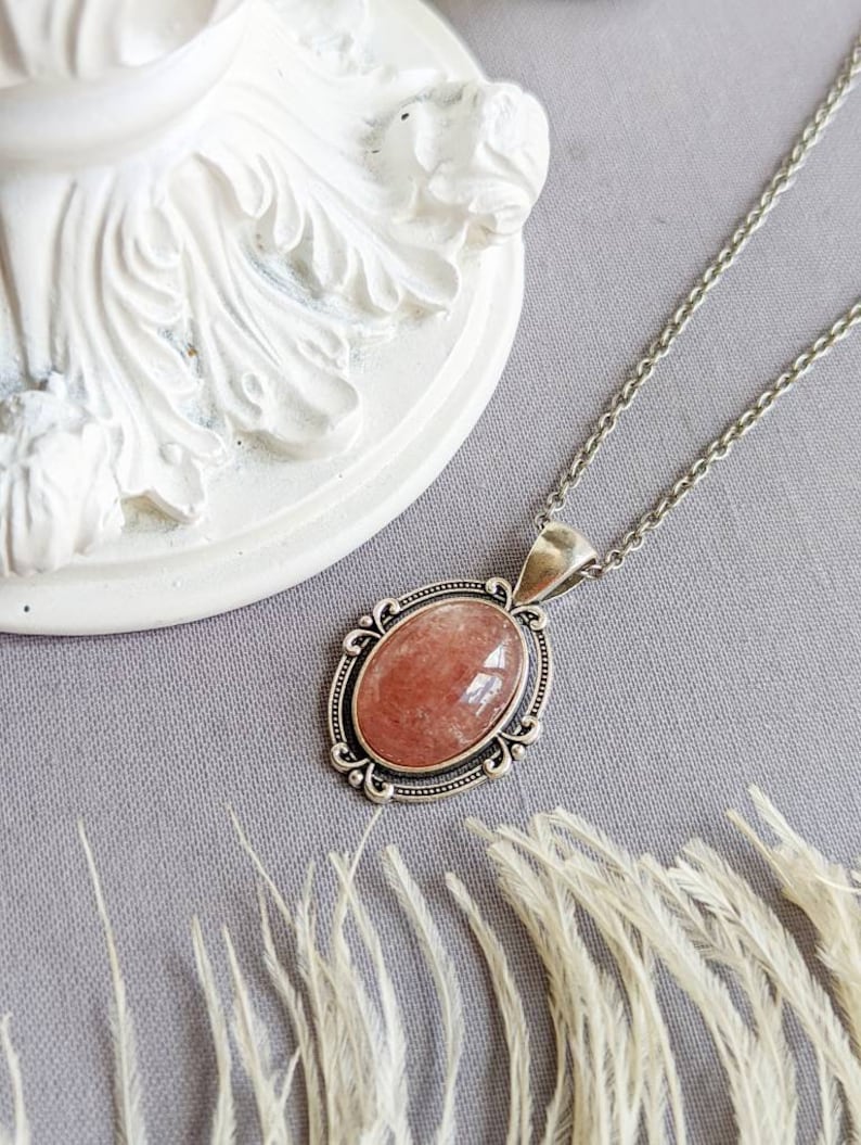 Medium Pink Strawberry Quartz Crystal Necklace - Silver Flourish Pendant Setting displayed on a grey background.